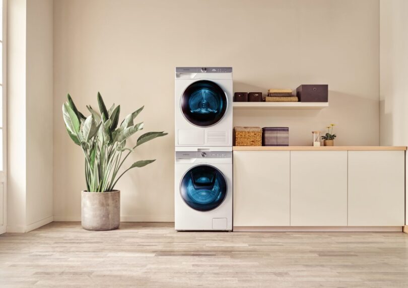 Duo de lave-linge et sèche-linge Samsung blanc au design épuré, installés en colonne dans une buanderie moderne et lumineuse, illustrant la nouvelle gamme équipée d'intelligence artificielle.